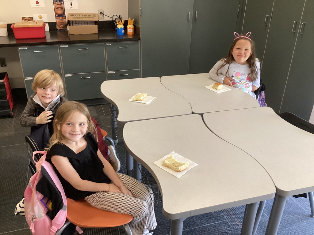 Kindergarten students enjoy butter bread during a Colonial Towns classroom experience.