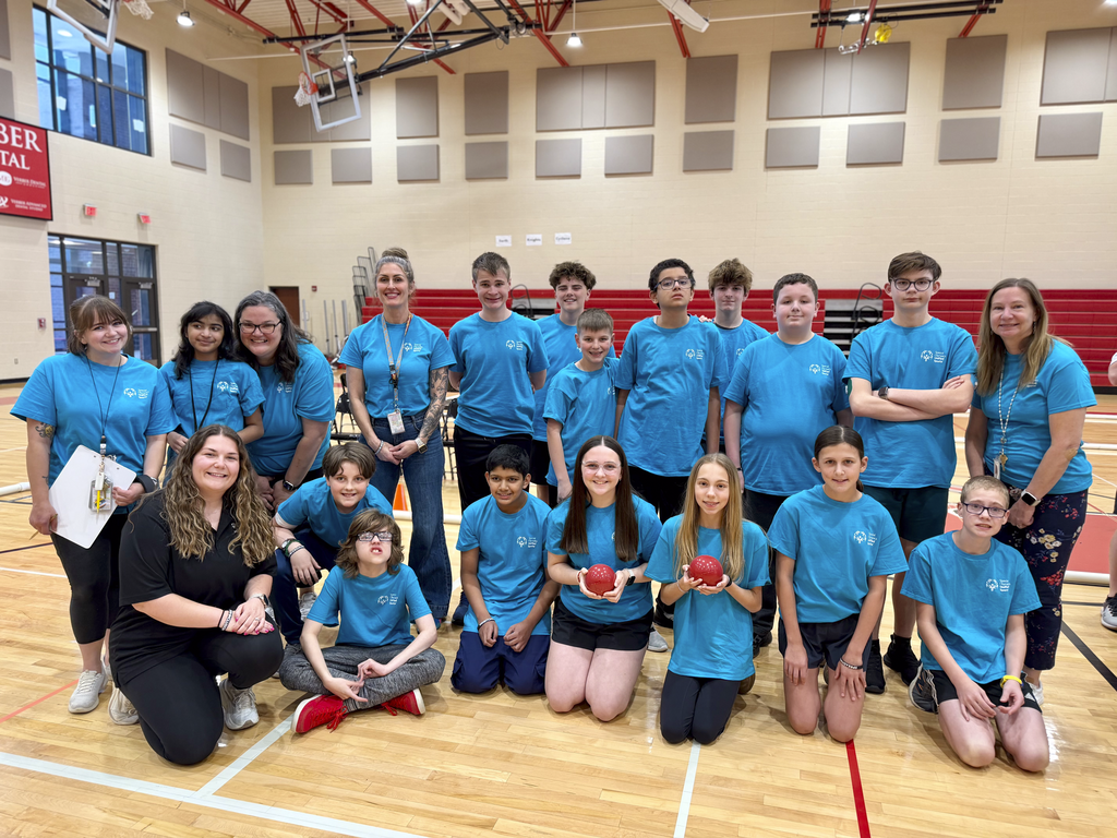Mountain View Middle School unified bocce team poses together in a gym, wearing matching blue shirts during the middle school bocce game.