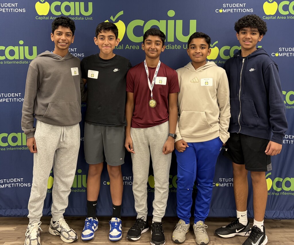 Eagle View Middle School 6th grade Math 24 team stands together at the CAIU Tournament backdrop after placing 5th, with one student wearing a medal.