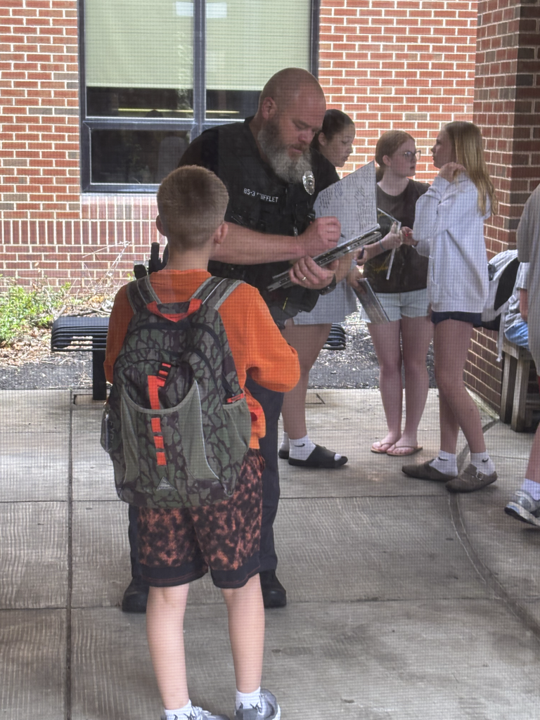 CV Police Officer, Sgt. Shifflet, signs a student's yearbook during the last day of school.