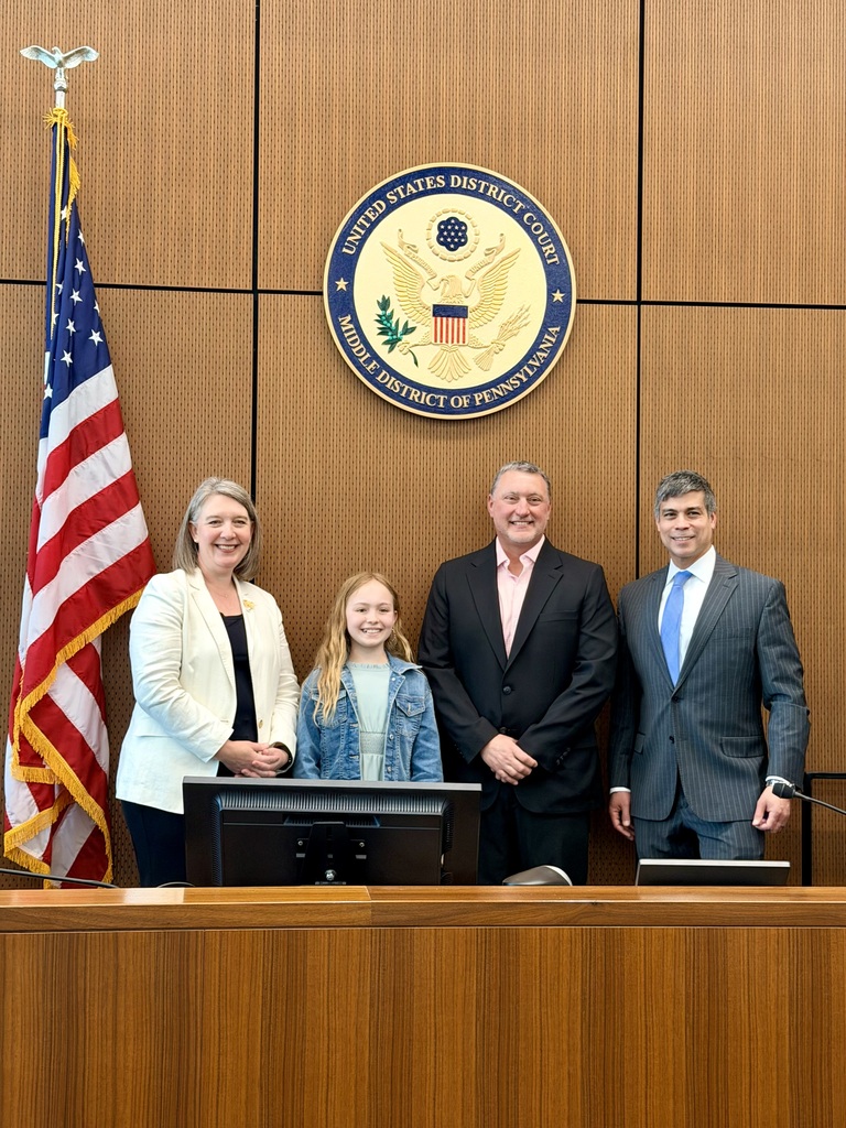 Eagle View Middle School student Aubree Kohl stands with court officials beneath the United States District Court seal after earning a Top 10 finish in a federal essay contest.