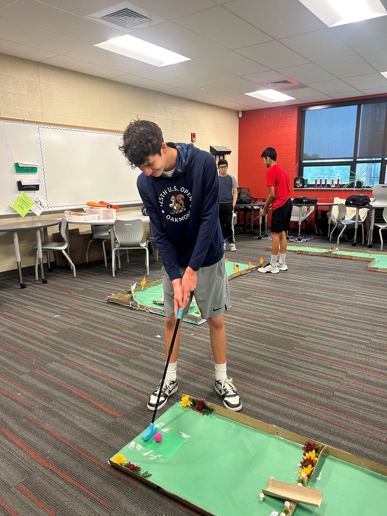 Mountain View Middle School student tries out a playable mini-golf hole created for an engineering project.
