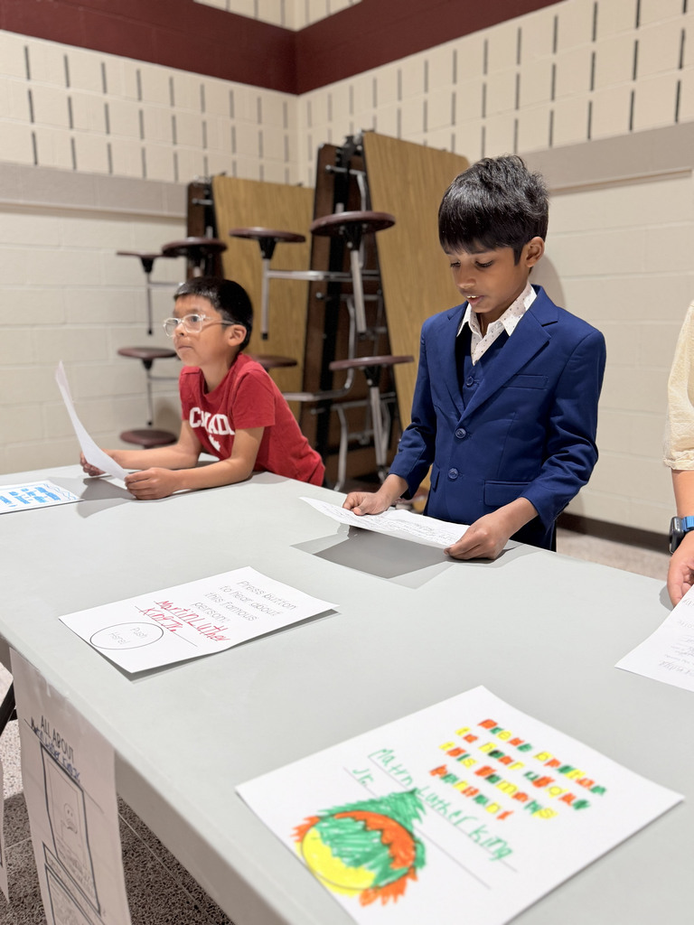 A Monroe Elementary second-grader dressed as Martin Luther King Jr. presents a biography project during the school's Wax Museum event.