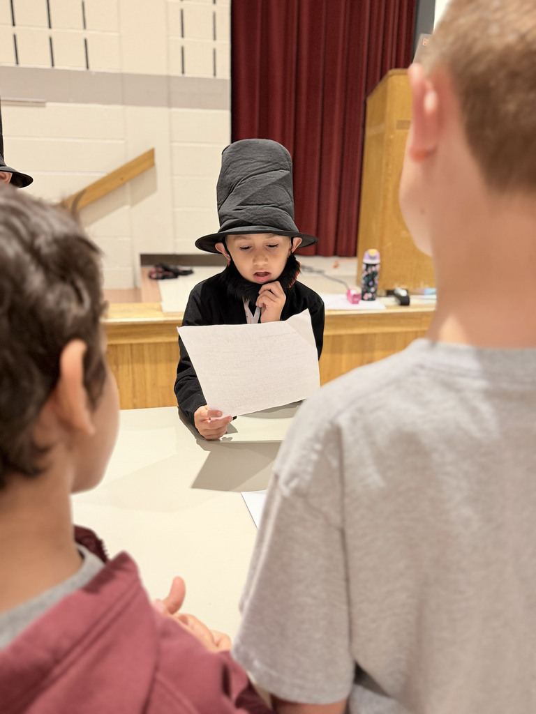 A Monroe Elementary second-grader dressed as Abraham Lincoln shares a presentation with classmates during the second-grade Wax Museum.