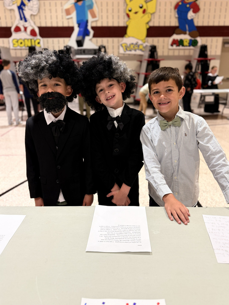 Monroe Elementary second-grade students dressed as Frederick Douglass pose during the school's Wax Museum project.