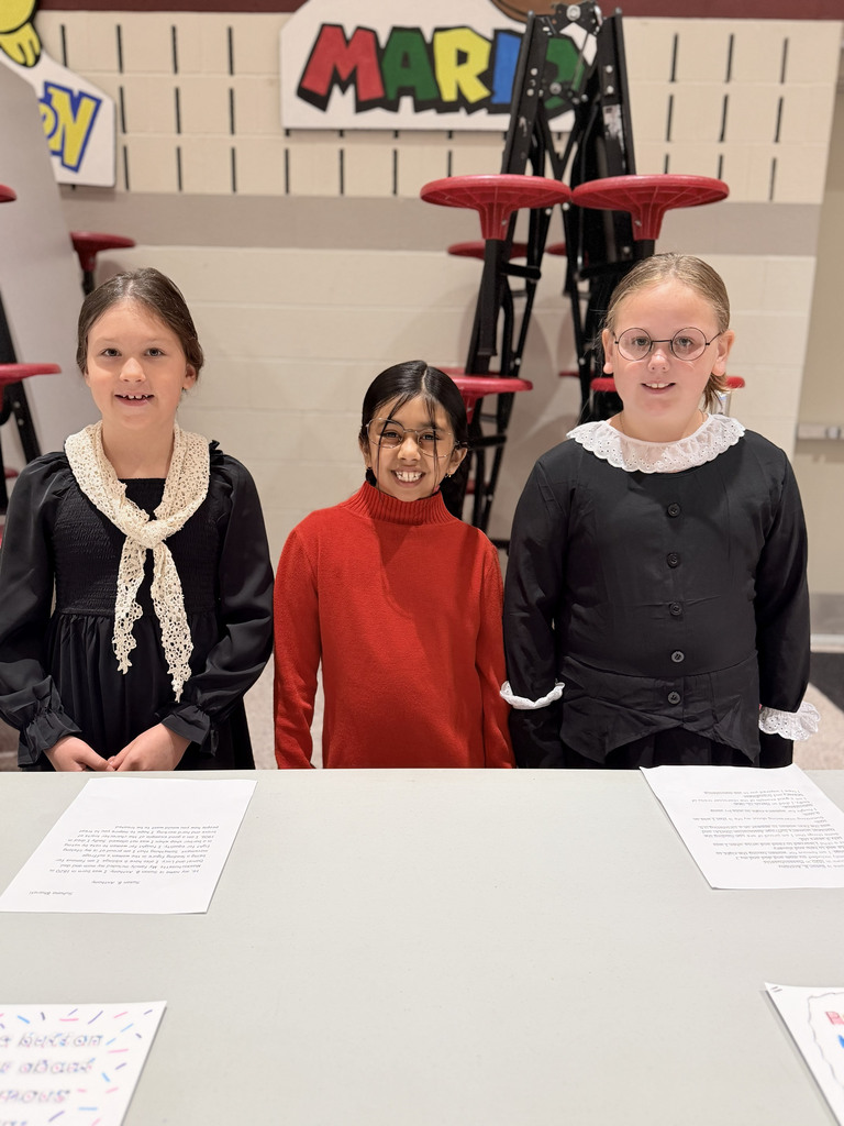 Monroe Elementary second-graders portraying Susan B. Anthony stand as living wax museum exhibits during the school's Wax Museum event.