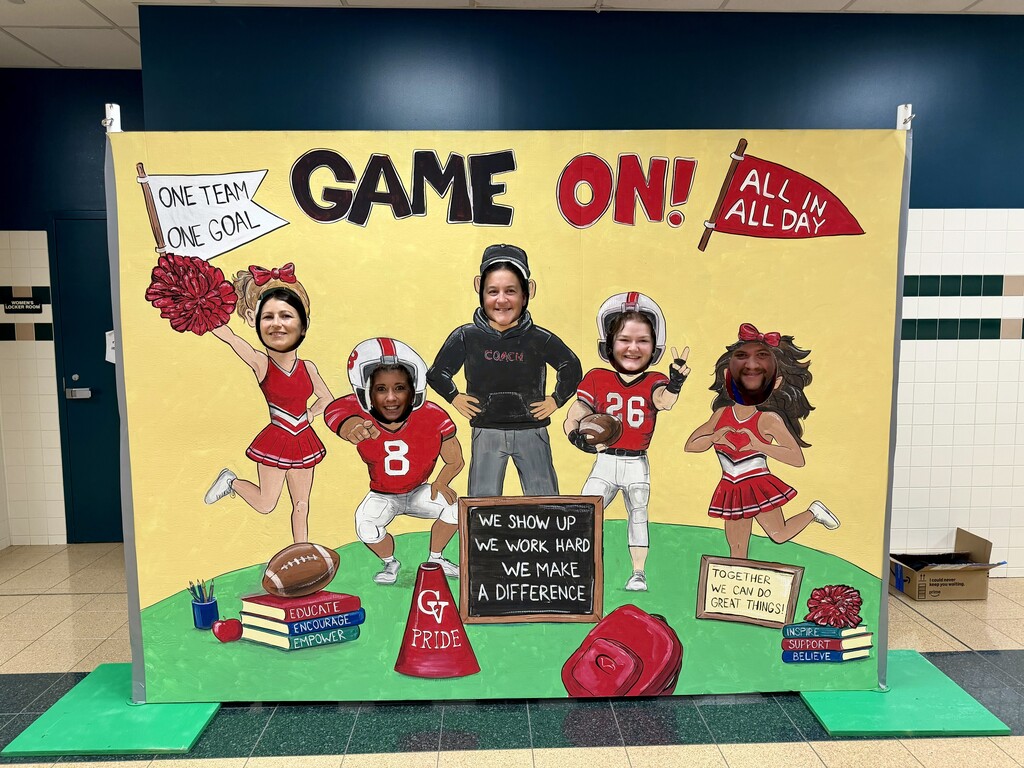Staff members pose with a football-themed photo backdrop during the 2026-27 Convocation.