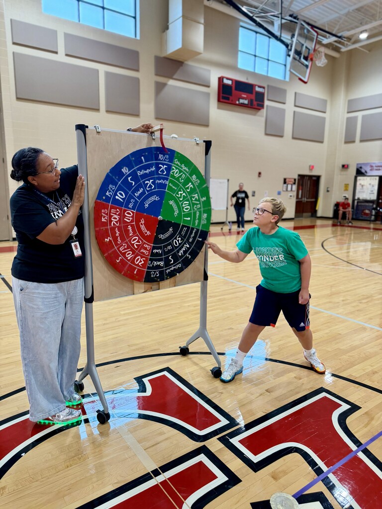 A student spins a prize wheel to earn House points during a game at Winding Creek Elementary’s House Assembly.