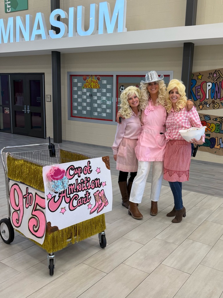 Winding Creek Elementary administrators celebrate 9-2-5 Day in Dolly Parton-inspired outfits.