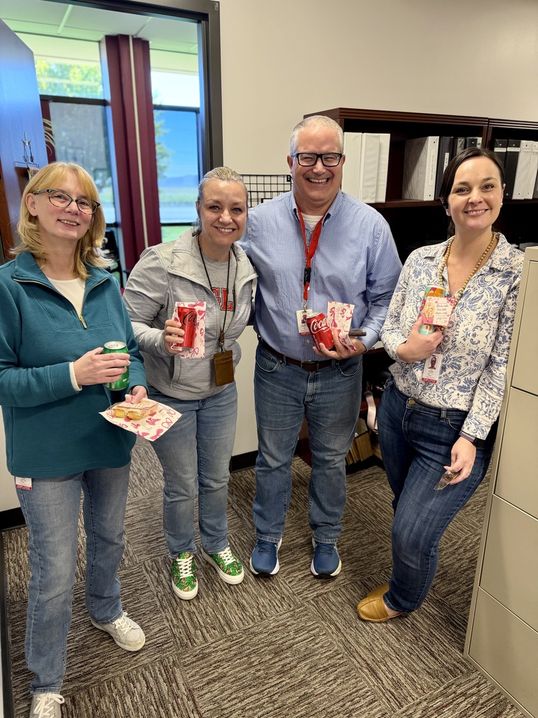 District Office Business Department staff pose together while enjoying drinks and treats.