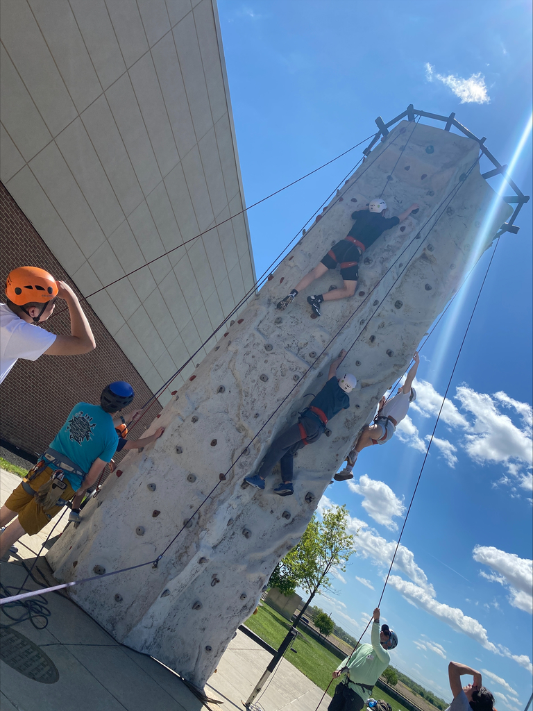 Students climbing a wall