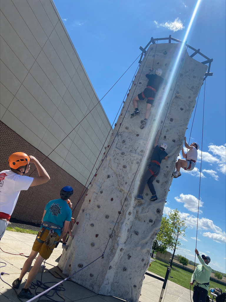 Students climbing a wall