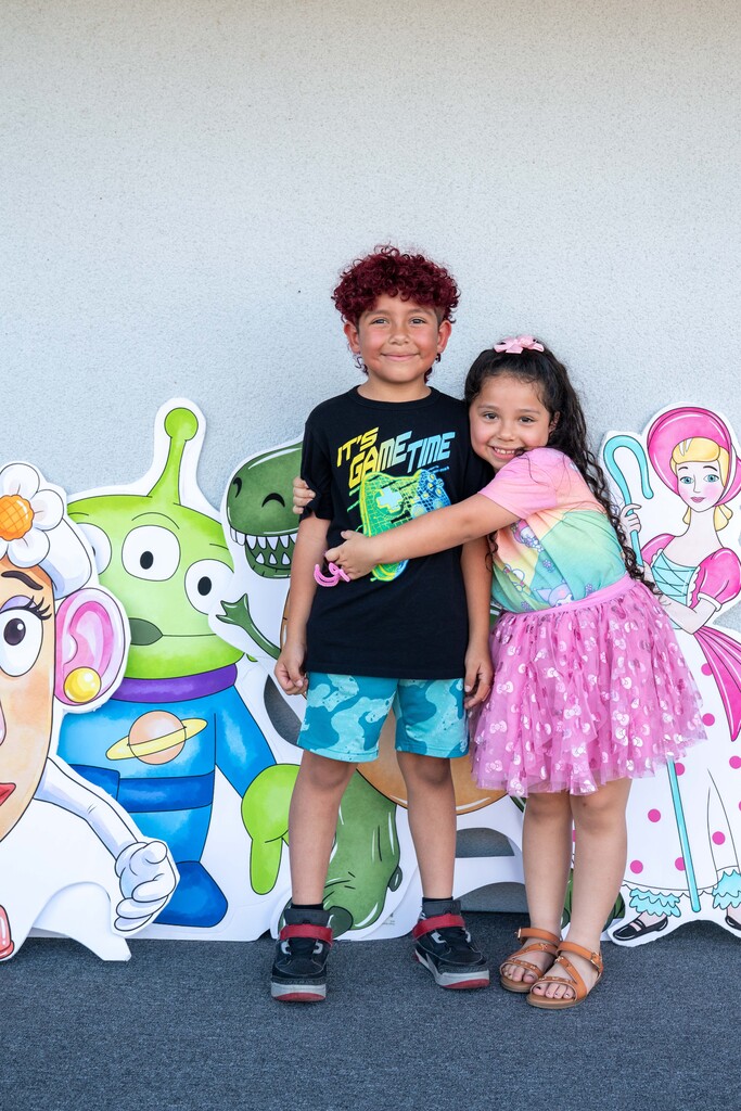two sibling are photographed hugging at the Cutler School Carnival