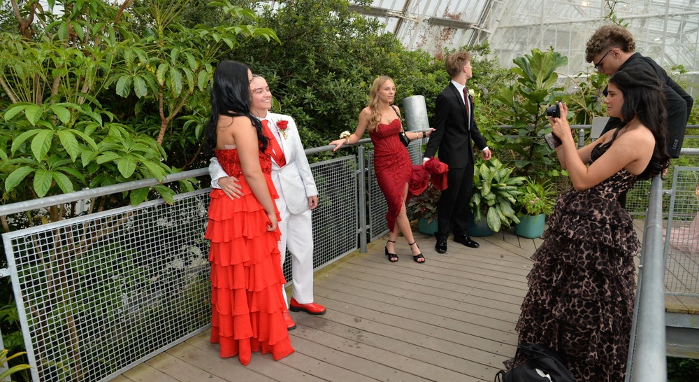 Prom Goers take photos in gardens.