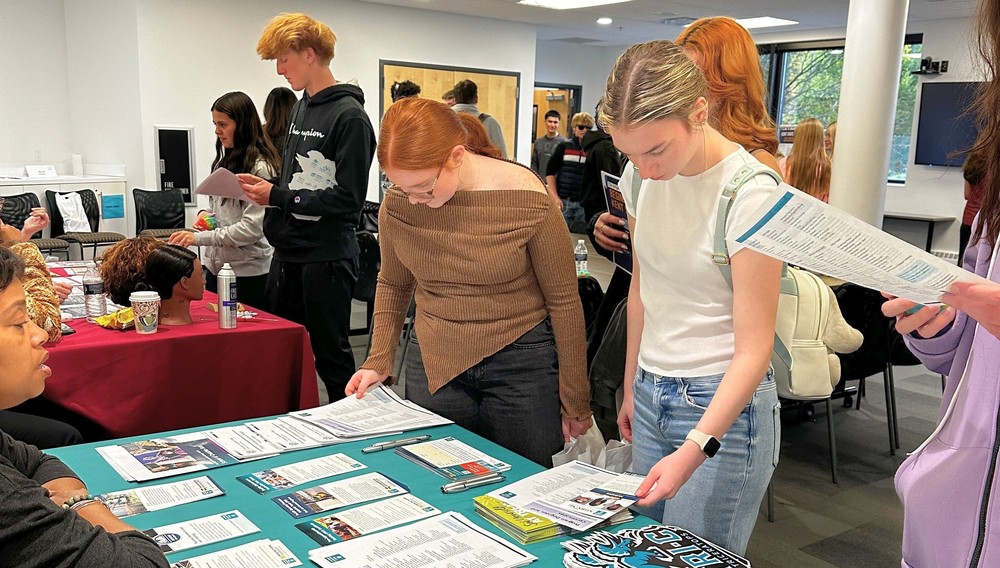 Students visit with exhibitors at E4ME event.