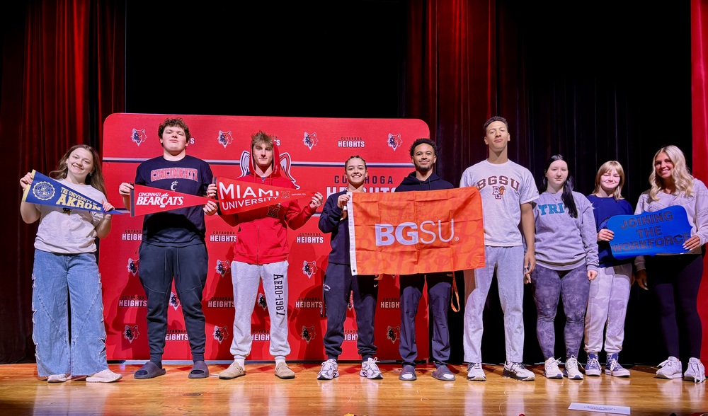 Students display thei respective college pennants. 
