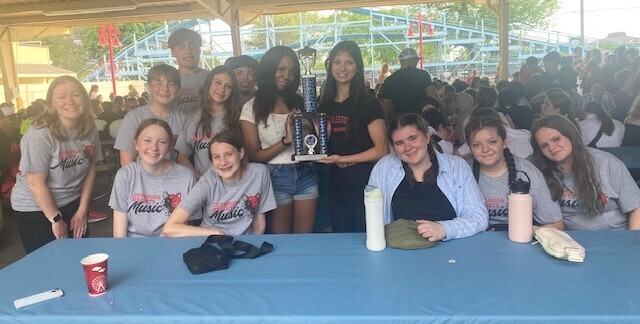 Orchestra students show trophy they won at Cedar Point.