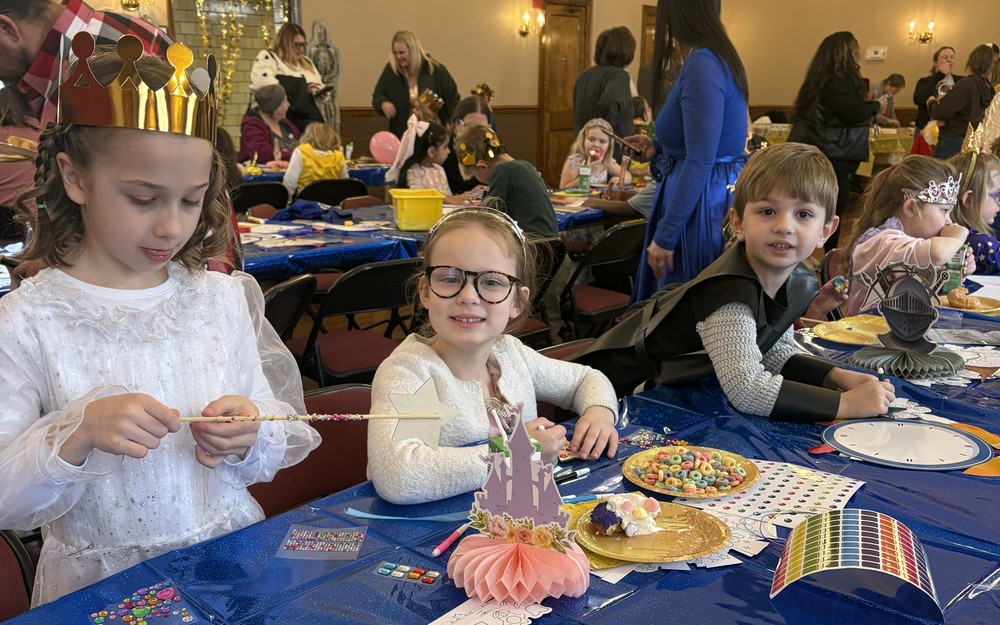 Girls making fruit loop necklaces