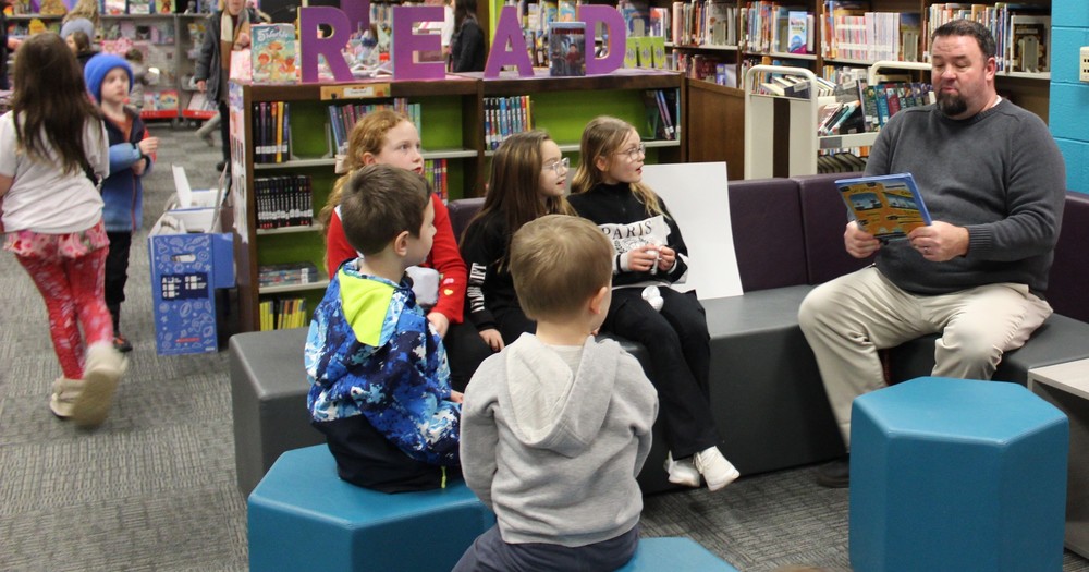 Principal Joel Melvin reads to students. at the GALA.