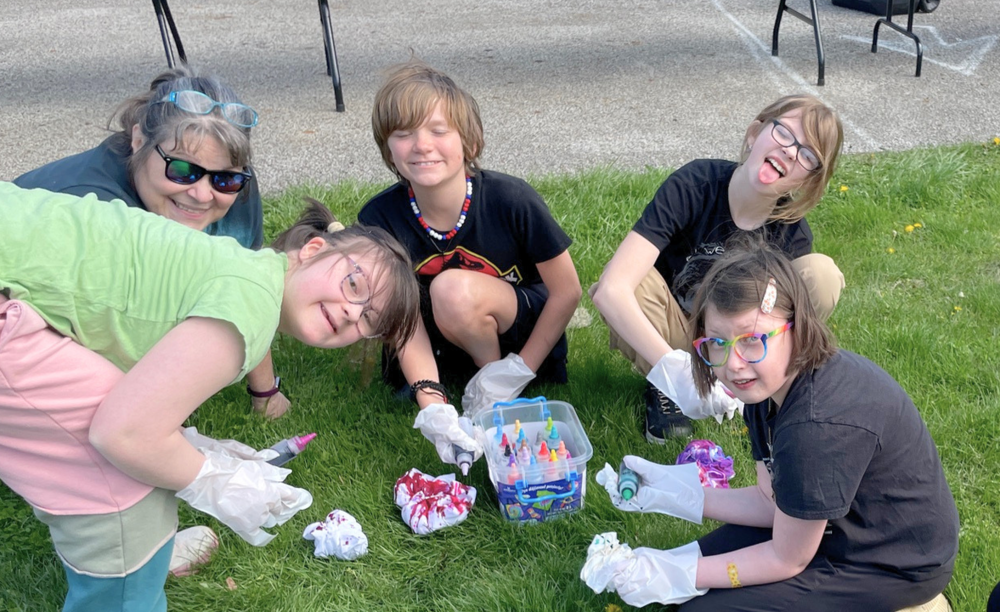 Students tie-dye items at Inclusion Mixer