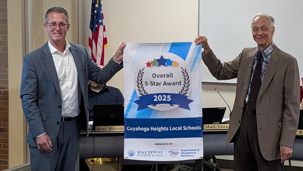 Superintendent Matt Young (left) and Board President Gary Suchocki with banner. 
