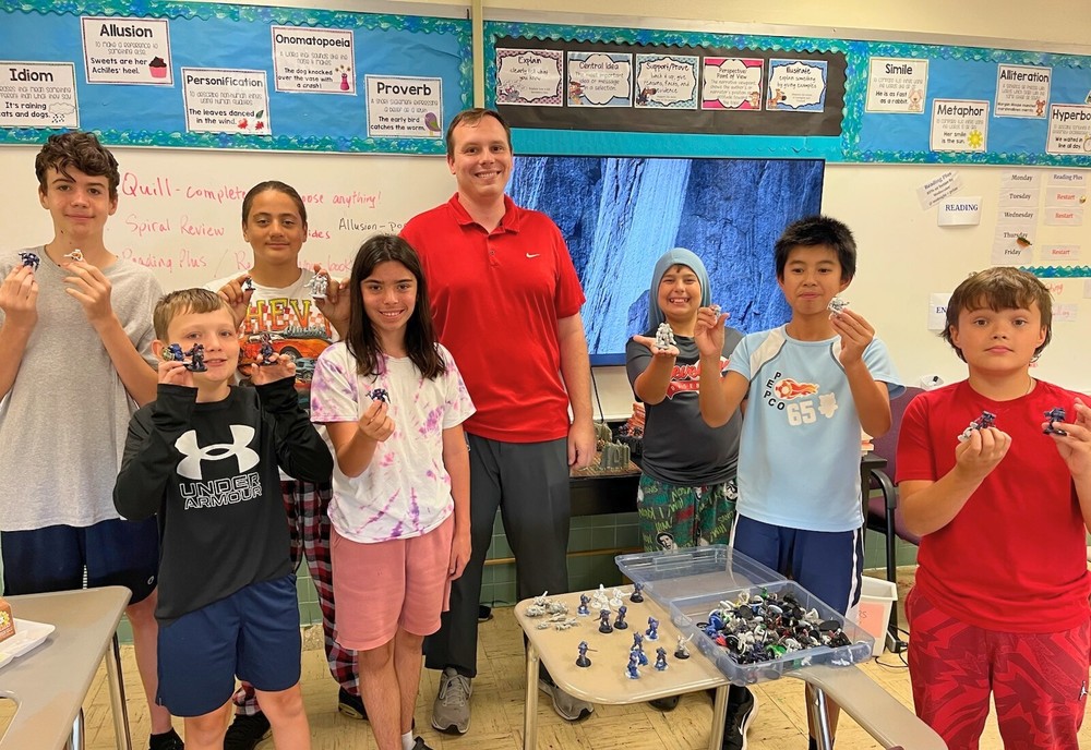 Matt Hartman (center) with members of the middle school Board Games Club