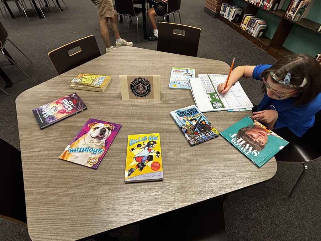 Today, Ms. Amato’s 6th grade class stopped by StarBOOKS — aka the MS/HS Library — to browse our “menu” of books. Just like placing a coffee order, students practiced making informed choices by reading the “flavor notes” to see what each book is all about before deciding on their perfect pick. Students learned the process of browsing books by scanning the cover, reading the blurb on the back, and pre-reading the first page to make sure their StarBOOKS order was just right.   Ms. Amato's students will return periodically to StarBOOKS to place a fresh order for new books!