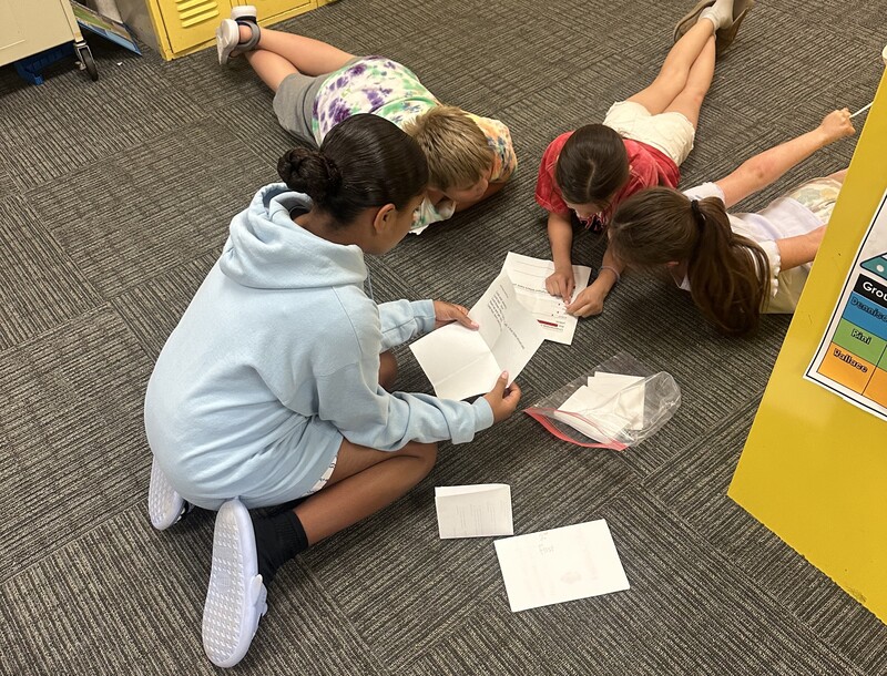 Students solve puzzles in Escape Room Project.
