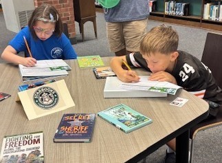 Two students rank books.