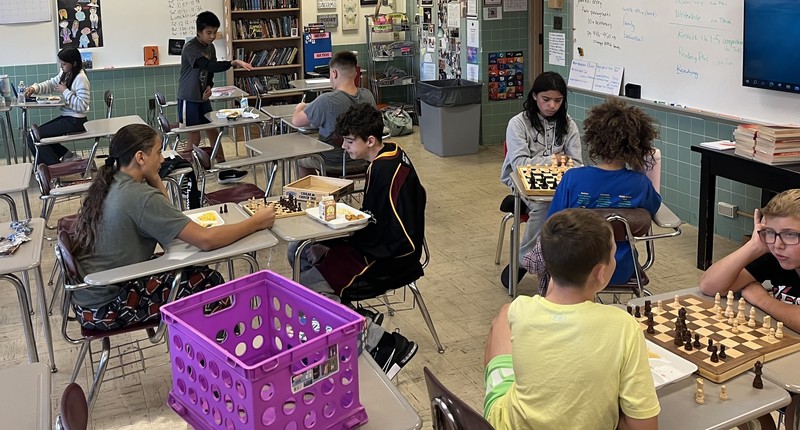 Students play board game.