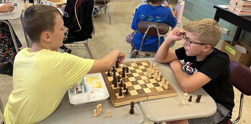 Two boys play chess. 