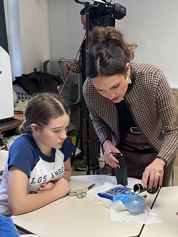 Walter demonstrates how ice reacts to an agent while Arianna Whoolery looks on.