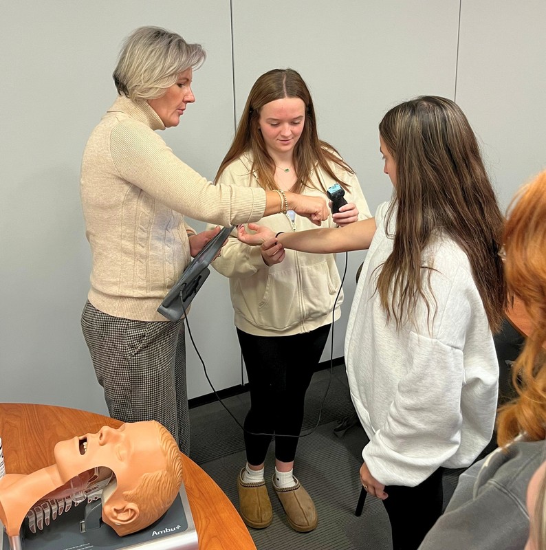 Students visit with exhibitors at E4ME event.