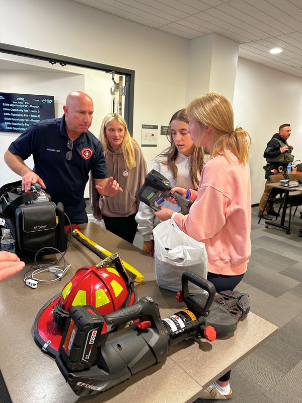 Students visit with exhibitors at E4ME event.