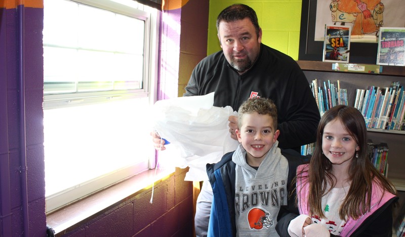 Students wait fro Principal Joel Melvin to drop their egg. 