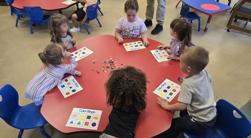 Pre-K strudent sworking at a table.