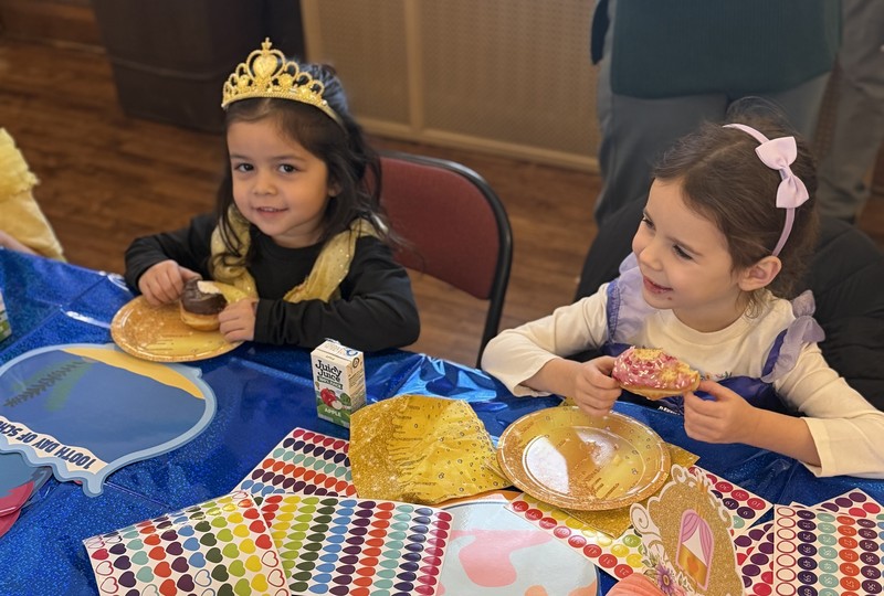 Girls enjoying  donuts.
