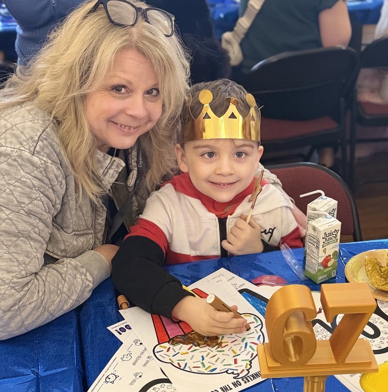 Adult with child coloring  a drawing. 