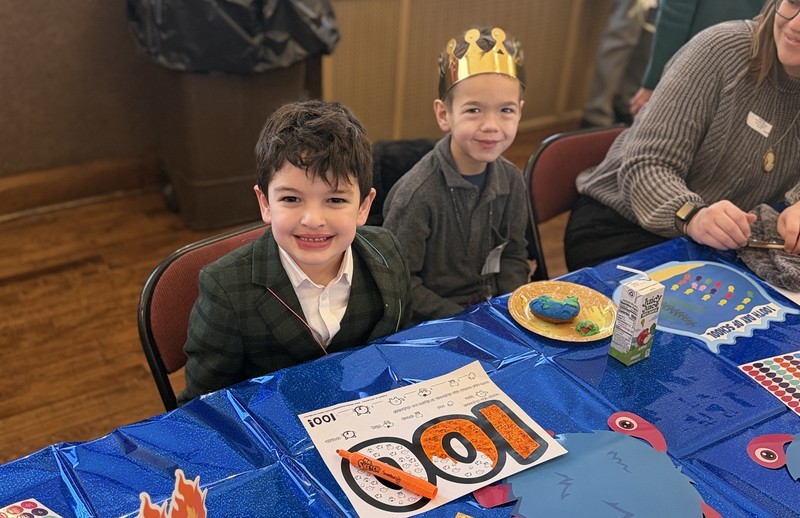 Two boys with 100-day drawing.
