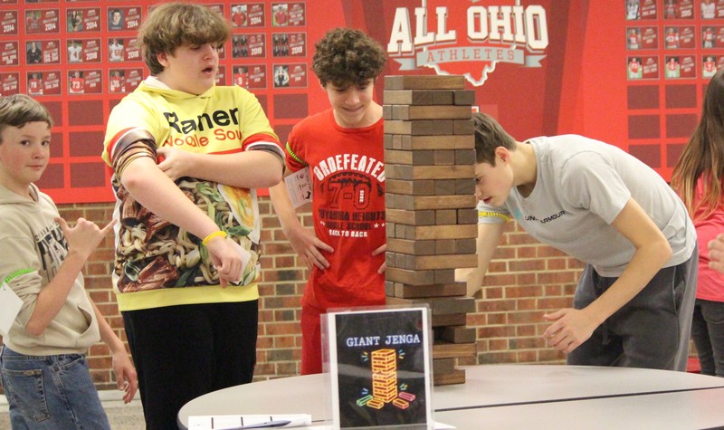 Boys play giant Jenga.