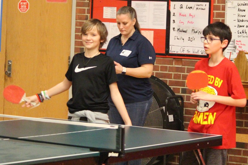 Students play ping pong.