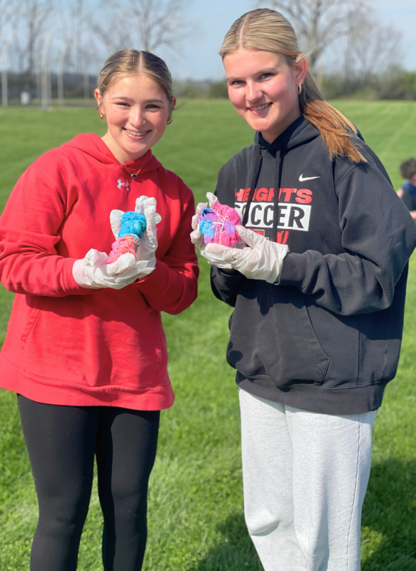 Students show  off thier tied-up tie-dyed t-shirts. 