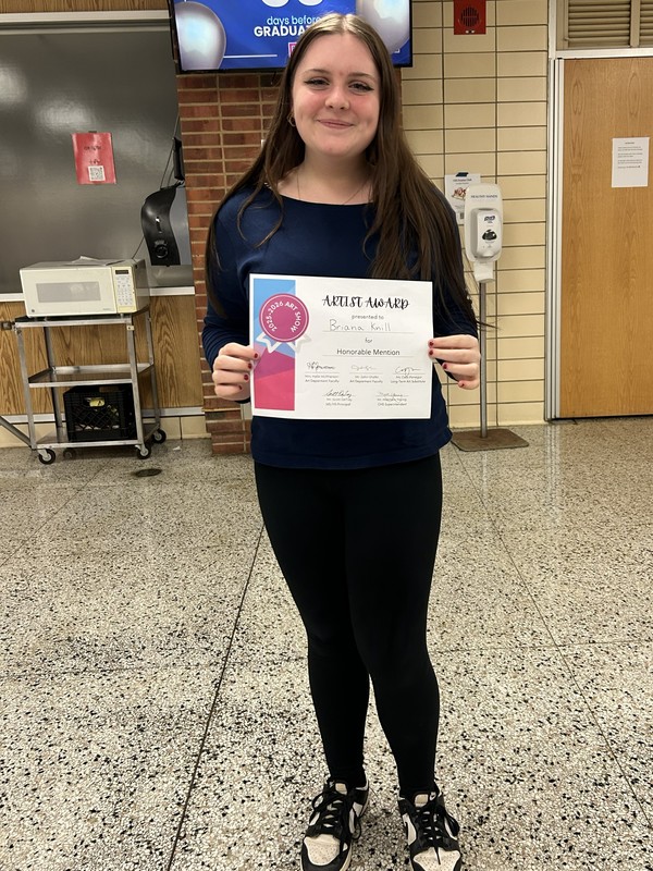 Brianna Knill shows off her award. 