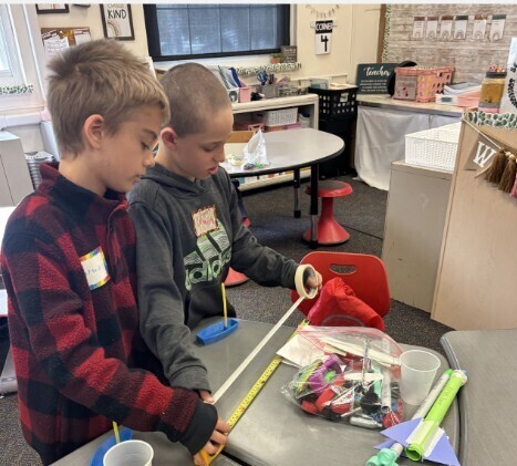 Boys work on their rocket
