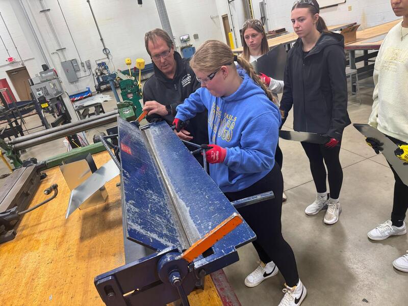 Students practice working on equipment. 
