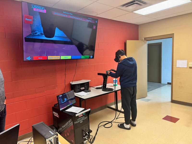 Male student works on equipment. 