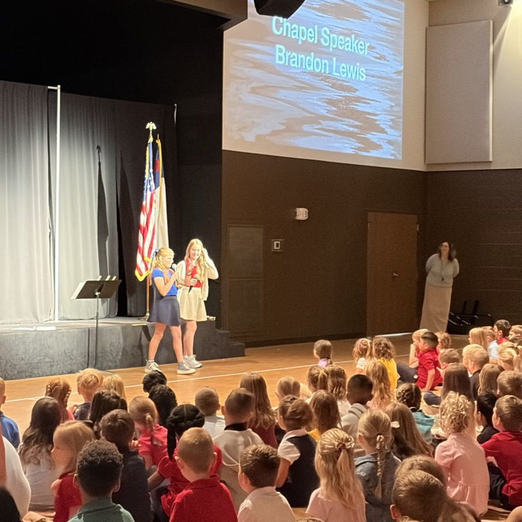 Two students introducing the speaker to students  