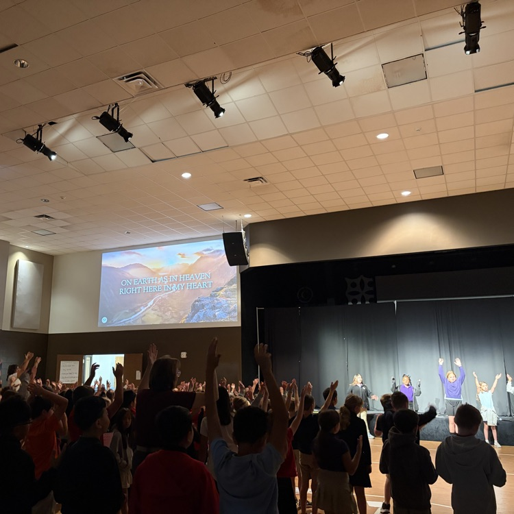 k-8 students in praise in worship