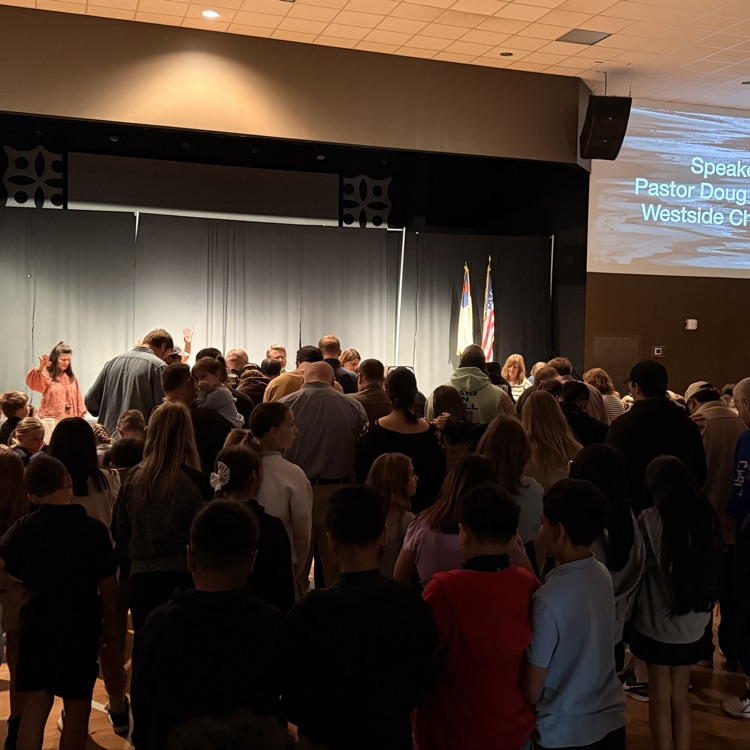 students and staff praying over