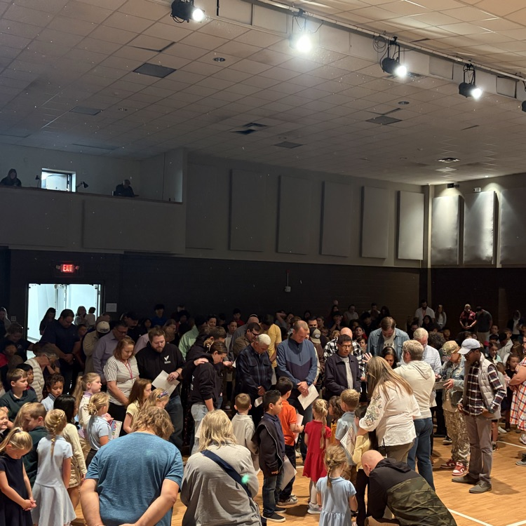 students and staff praying over pastors